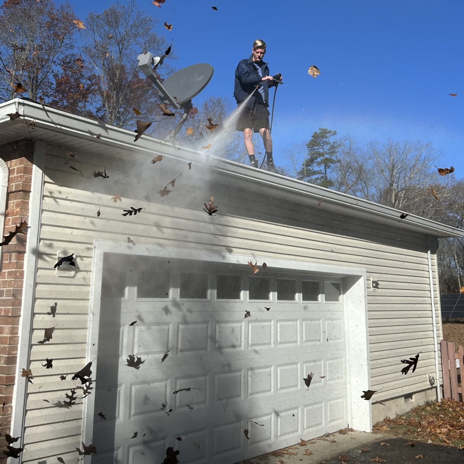 Roof soft washing in progress in Brick, NJ